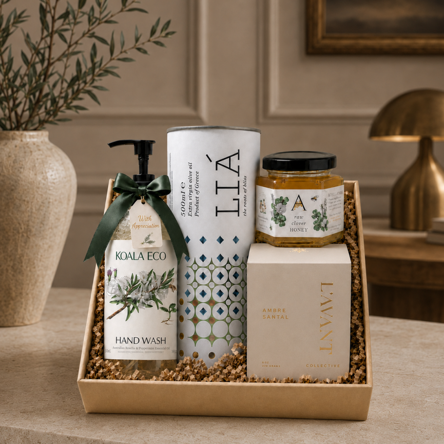 curated gift box with artisan orange blossom honey, a luxury amber sandal candle, Lia EVOO in unique packaging, and upscale Hand Wash.